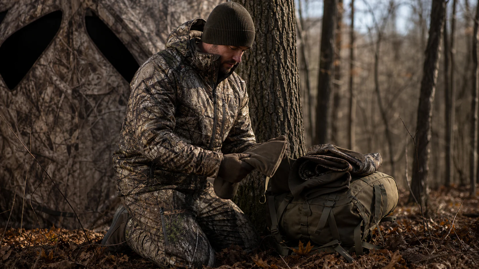Hunter preparing whitetail layers before a stand sit
