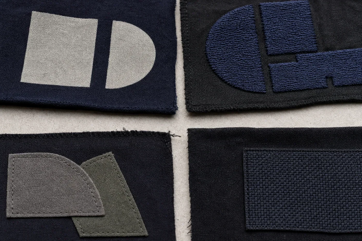 Representative embroidery, applique and patch method samples on dark fabric